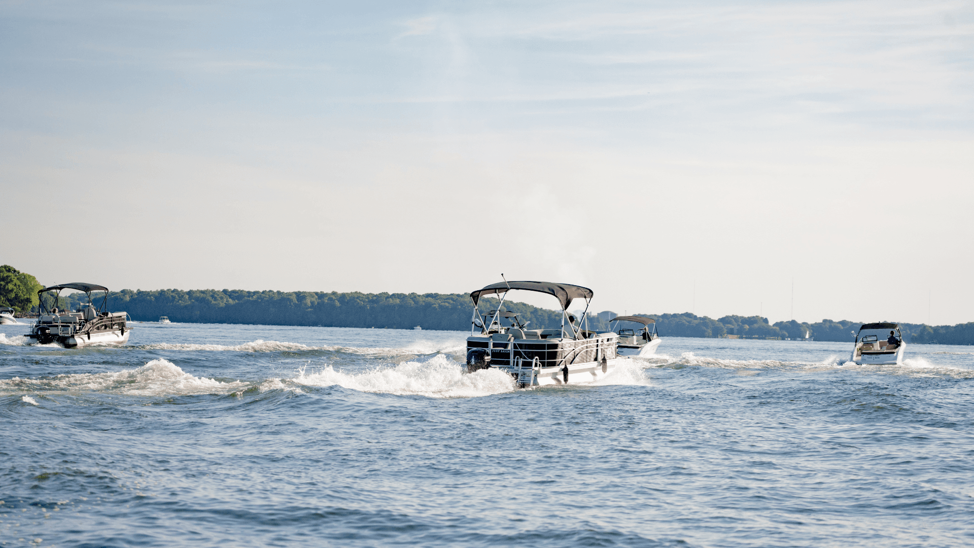 Aerial view of Lake Wylie at sunset with pontoon boats on the water